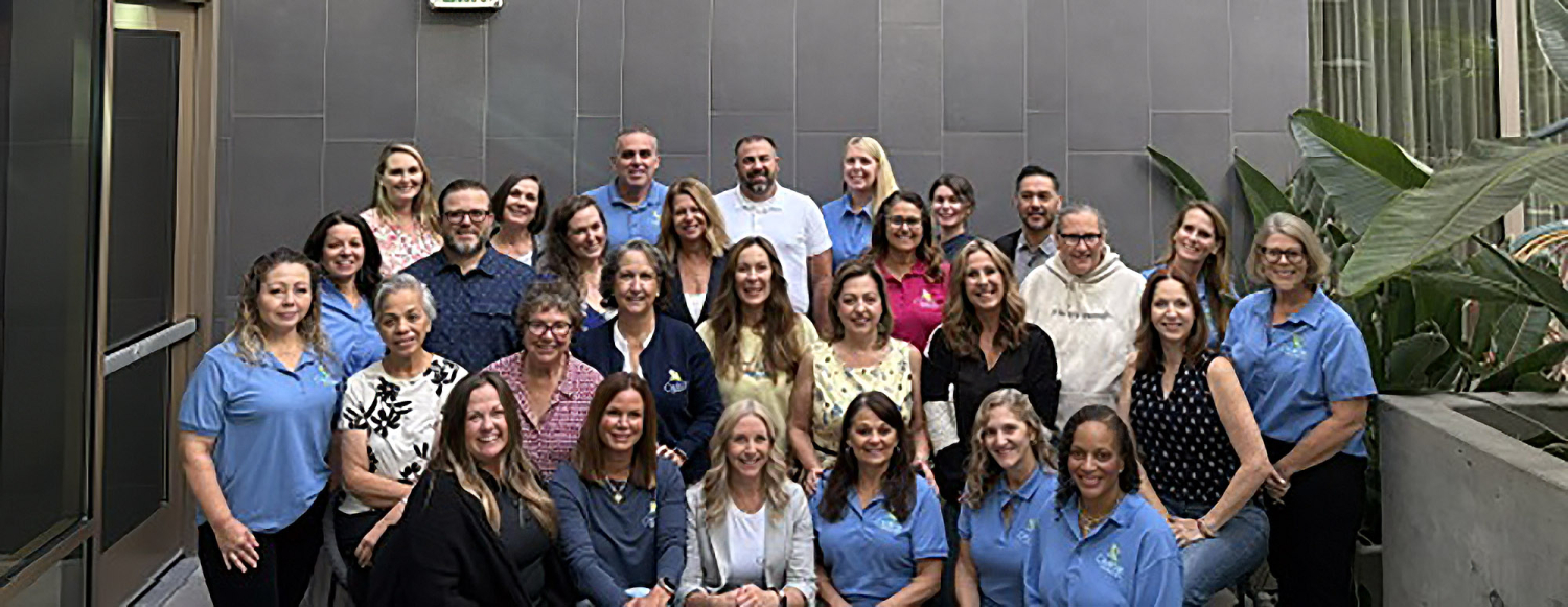 29 people facing forward and smiling